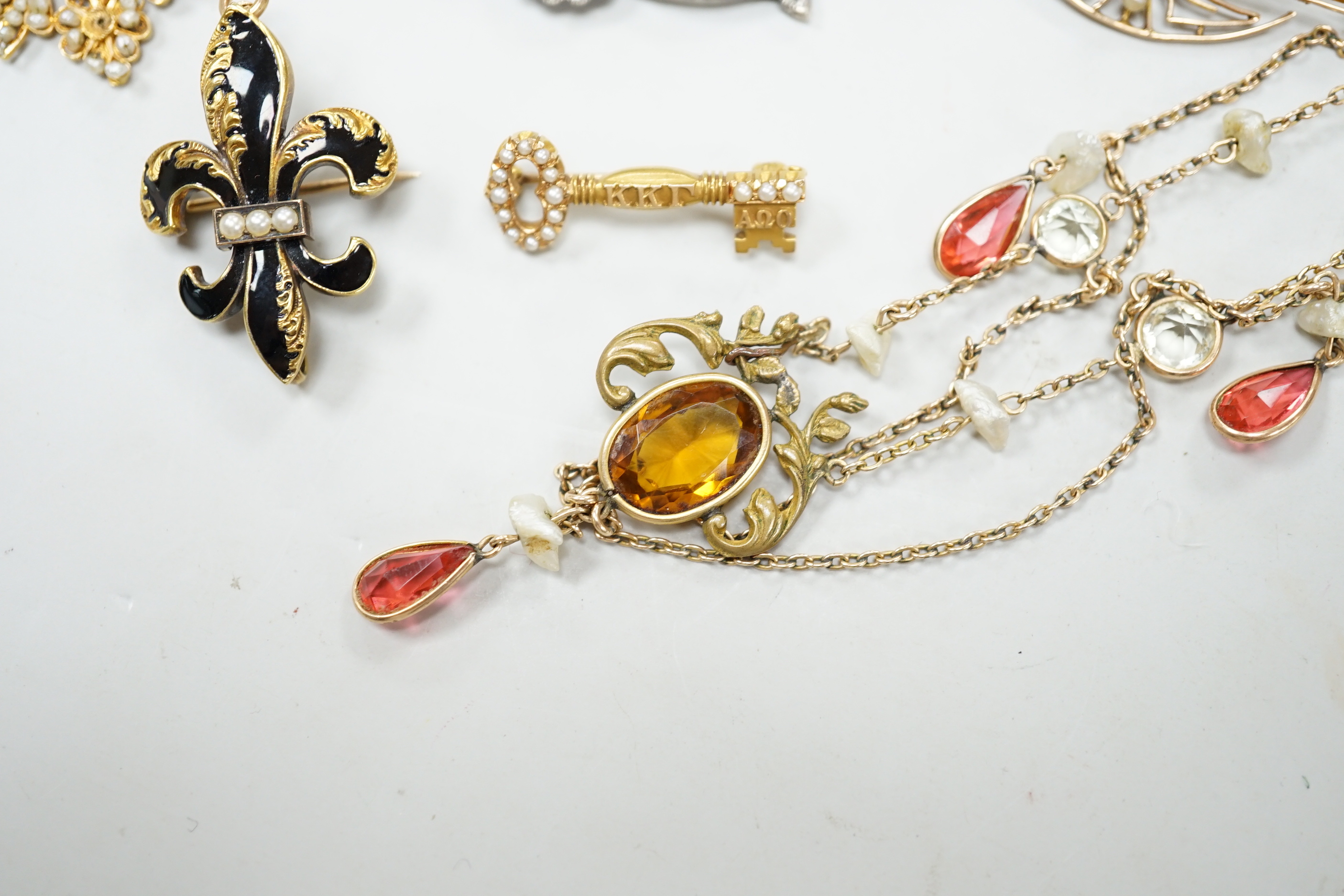 A small group of antique and later jewellery, including 9ct gold and bloodstone fob seal, a 1930's yellow metal and seed pearl set key brooch, 14k and black enamel brooch, spinning fob pendant, coral hand charm, 10k and